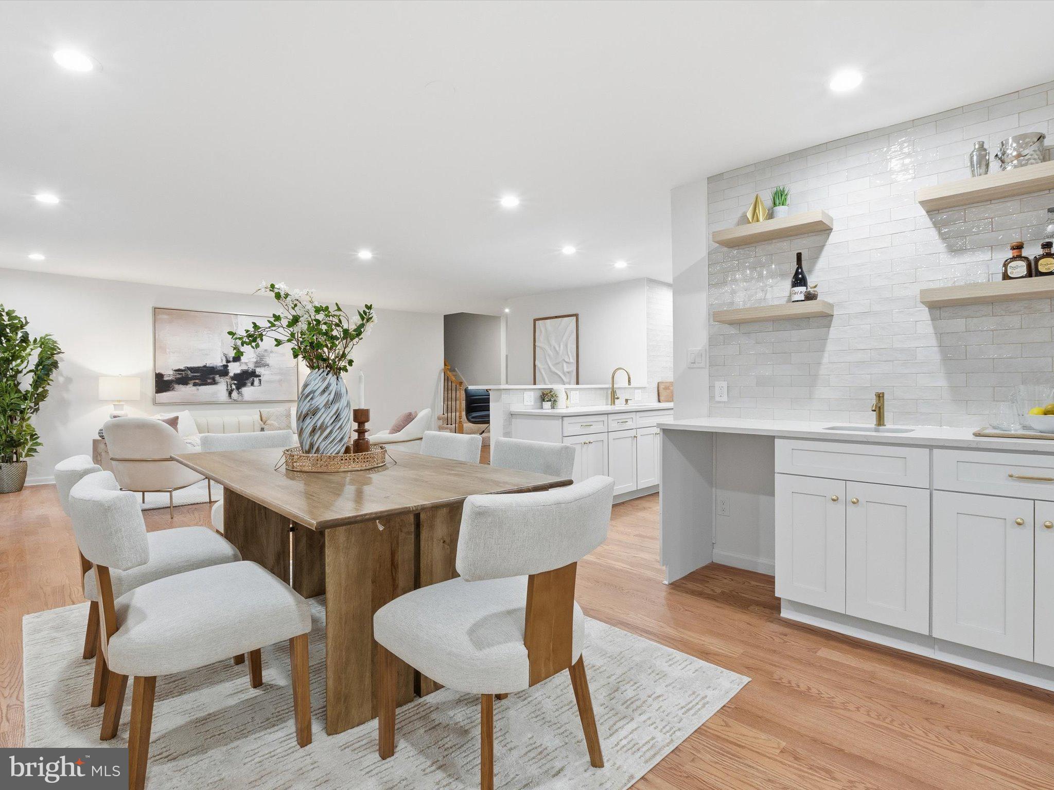 2133 Freda Drive Vienna, VA 22181 - Photo 9 of 45 a kitchen with a dining table chairs sink and cabinets