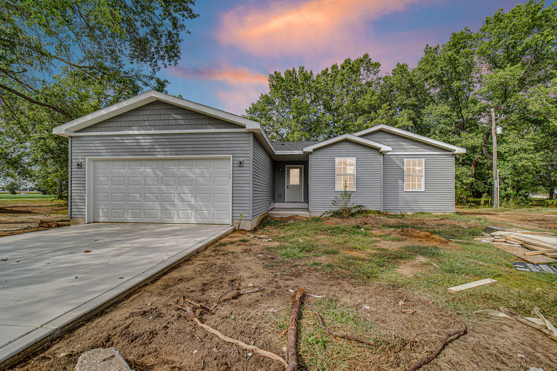 303 Malvern Road Kingsford Heights, IN 46346 - Photo 2 of 9 a view of a house with a yard plants and large tree