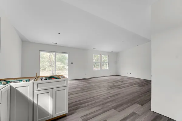 a view of kitchen with granite countertop cabinets appliances and a window