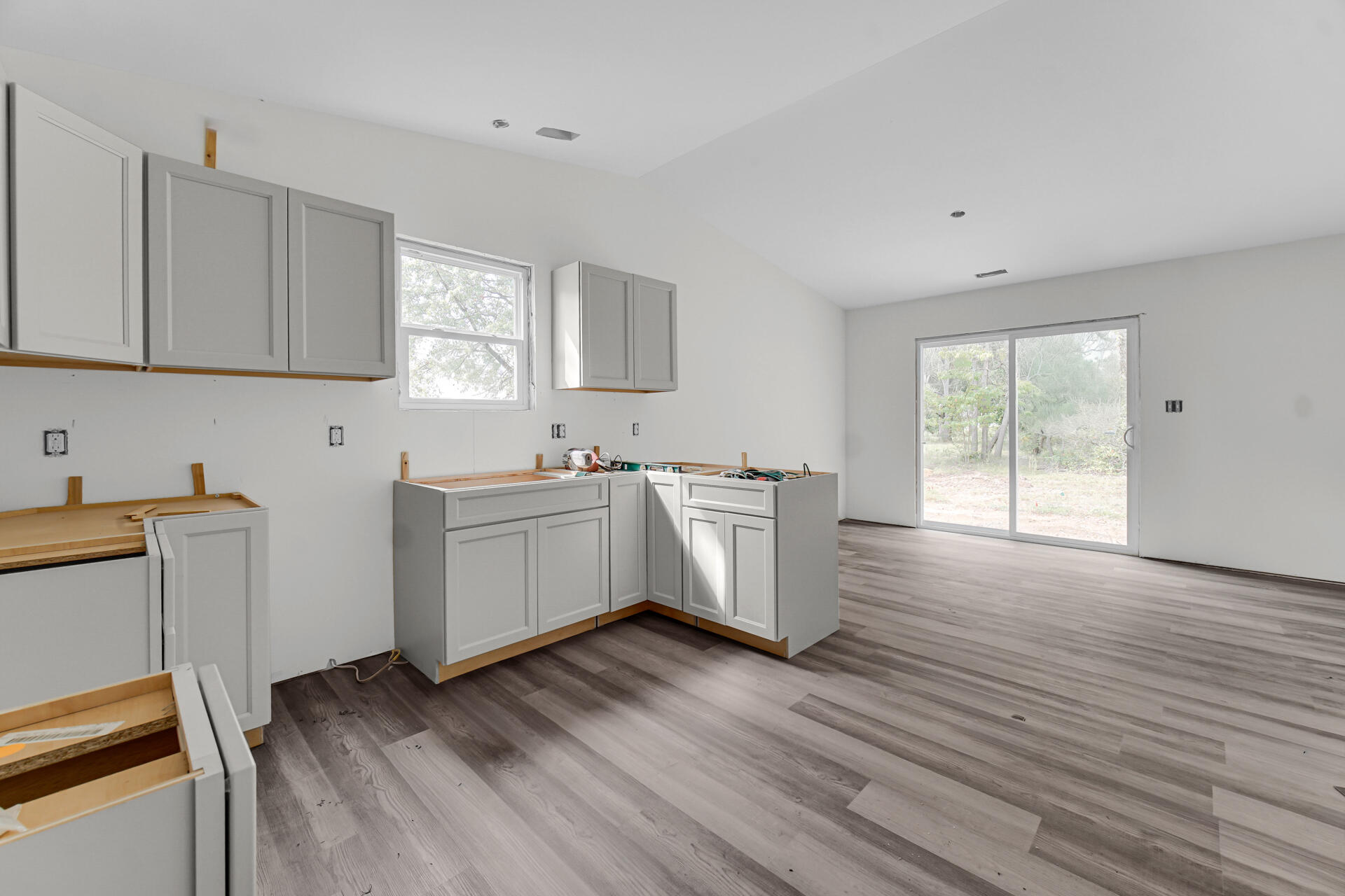 303 Malvern Road Kingsford Heights, IN 46346 - Photo 5 of 9 a view of a kitchen with wooden floor and electronic appliances