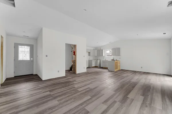 a view of empty room with wooden floor