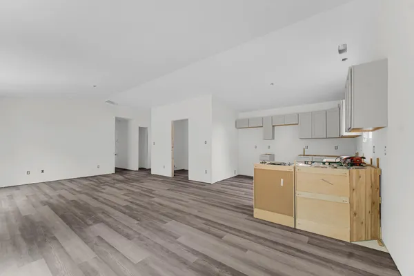 a view of a kitchen with stove and cabinets