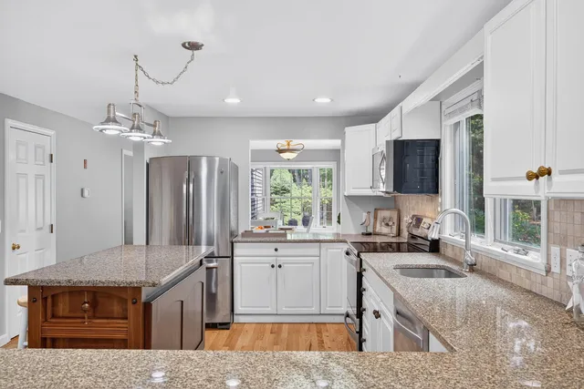 a view of a livingroom with furniture staircase windows and entryway