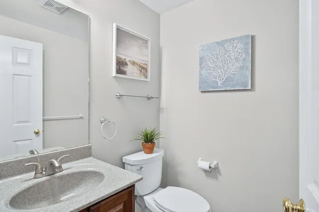 a bedroom with a bed and a potted plant