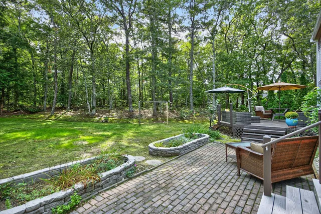 a view of a hallway with wooden floor and entryway