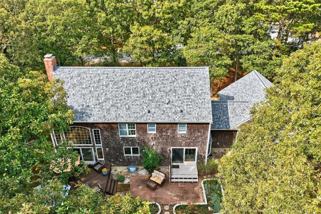 a kitchen with granite countertop a stove a sink dishwasher and white cabinets with wooden floor