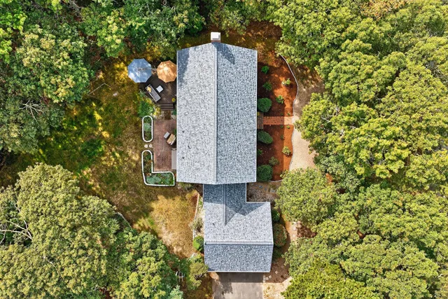 a kitchen with a sink and a stove top oven with wooden floor