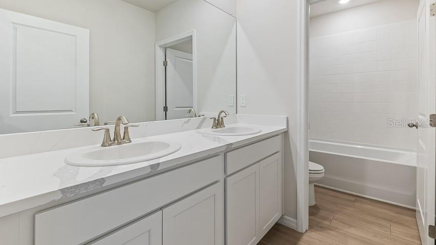 1925 Cobb Trail Parrish, FL 34219 - Photo 19 of 25 a bathroom with a sink and a mirror