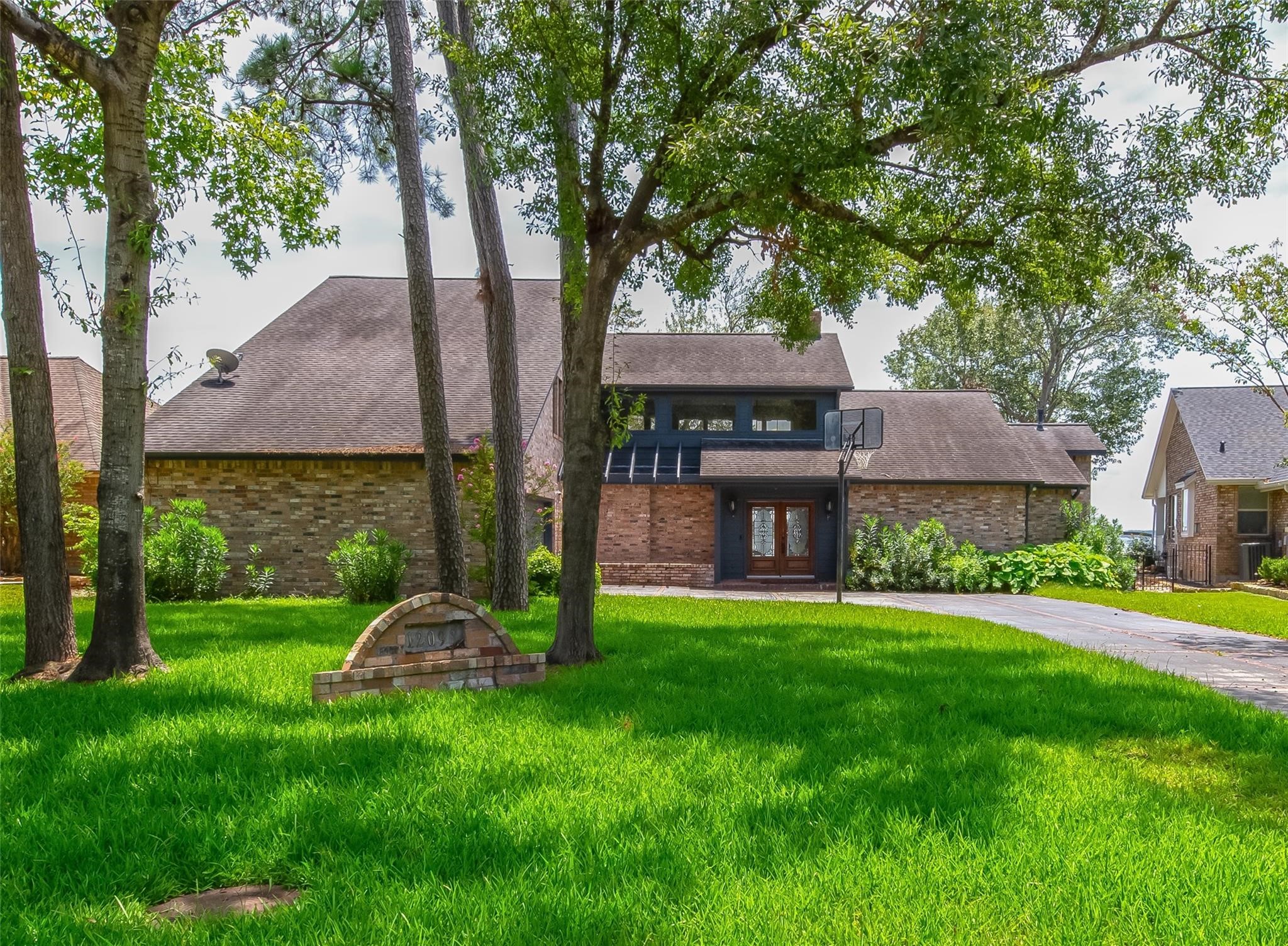 12098 Sagittarius East Willis, TX 77318 - Photo 2 of 37 a view of a house with a yard and a large tree
