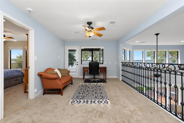 a living room with furniture a rug and a chandelier