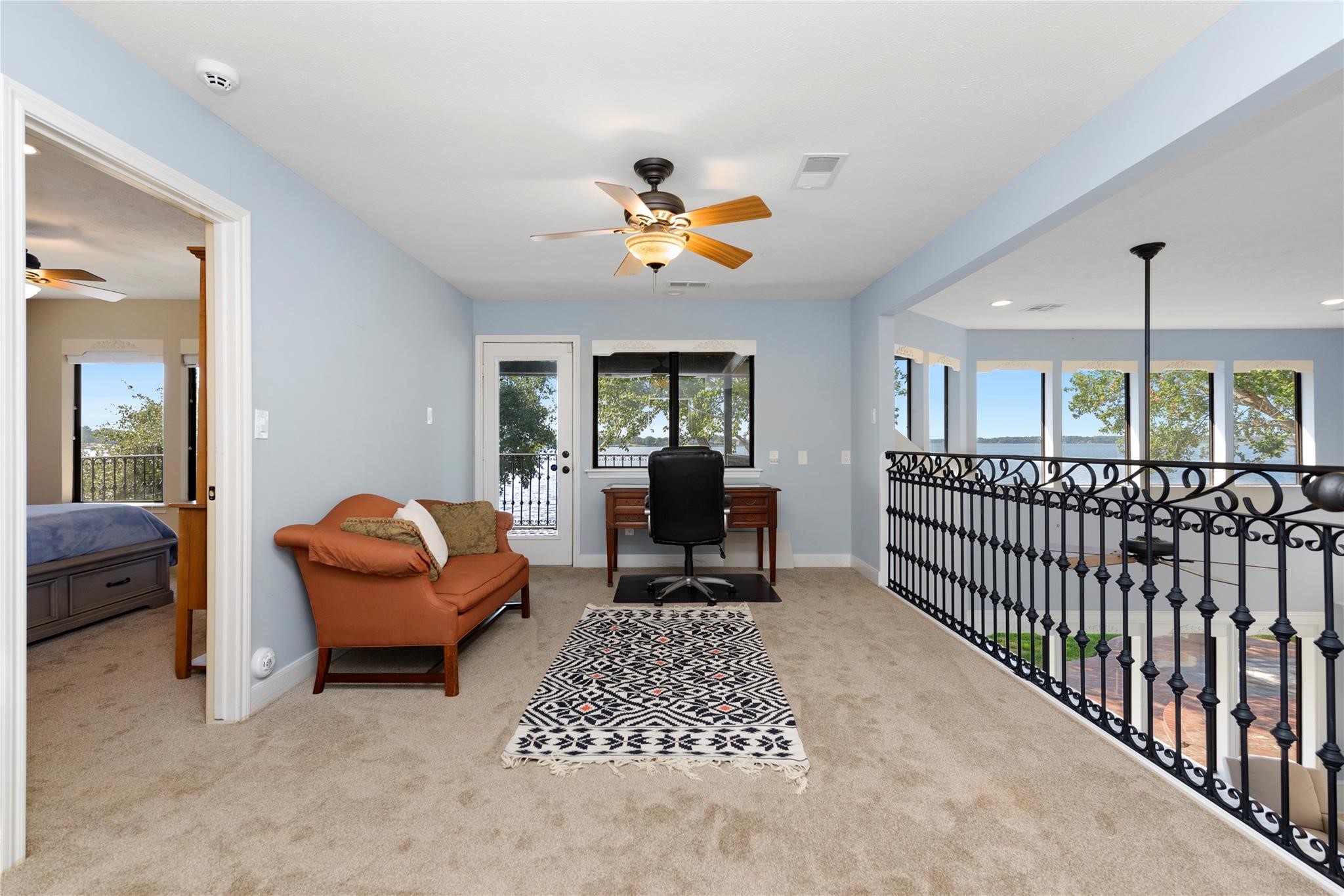 12098 Sagittarius East Willis, TX 77318 - Photo 23 of 37 a living room with furniture a rug and a chandelier
