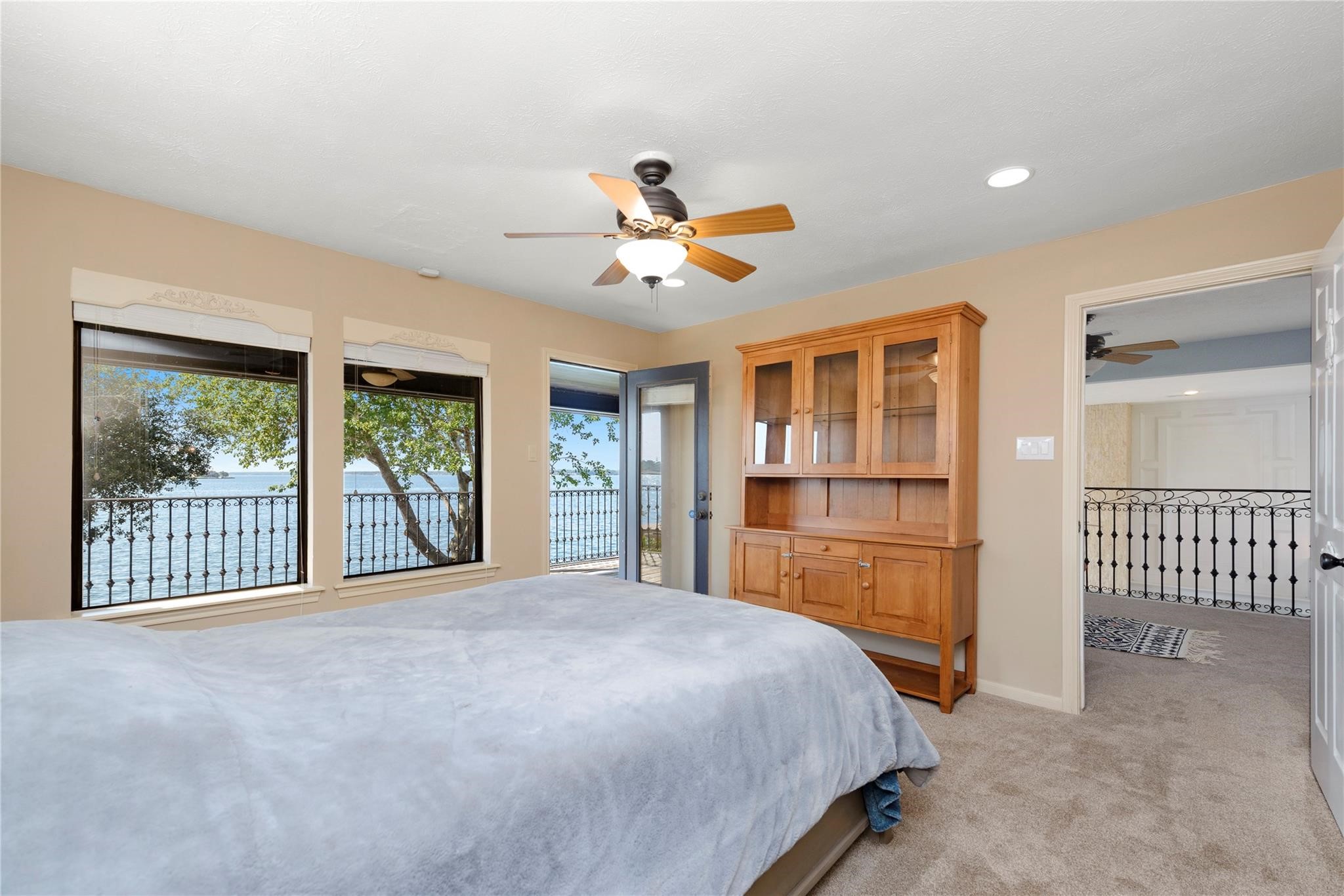 12098 Sagittarius East Willis, TX 77318 - Photo 25 of 37 a bedroom with a large bed and a chandelier