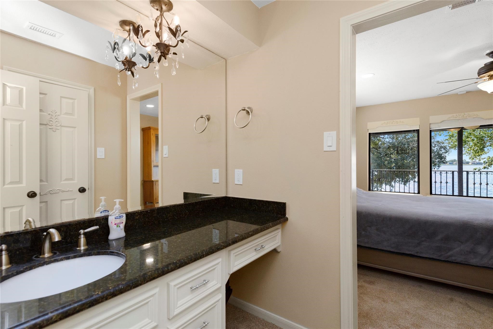 12098 Sagittarius East Willis, TX 77318 - Photo 28 of 37 a bathroom with a granite countertop sink a large mirror and shower