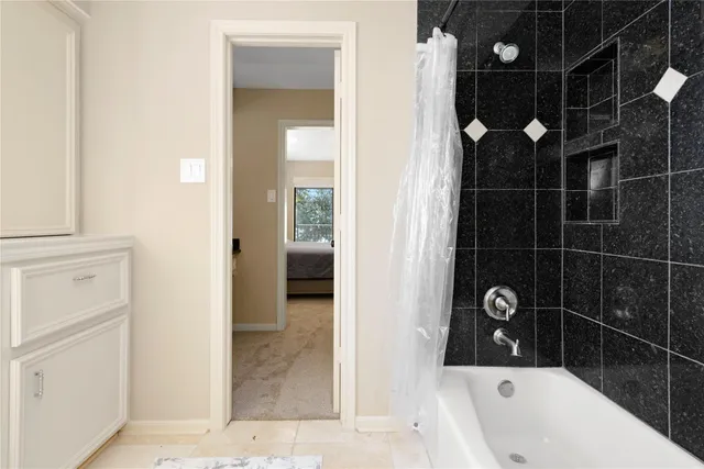 a bathroom with a bathtub and shower