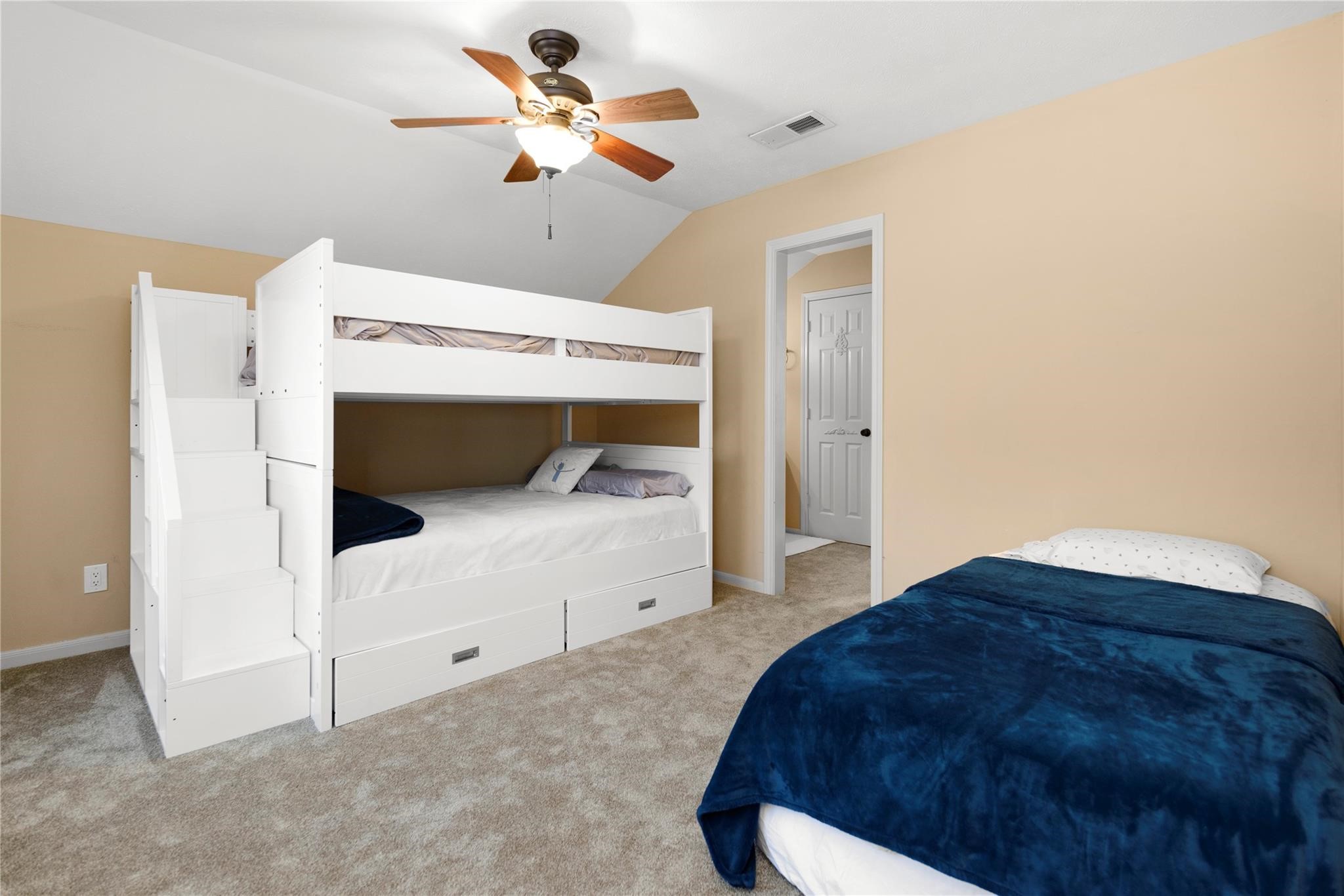 12098 Sagittarius East Willis, TX 77318 - Photo 30 of 37 a bed room with a bed and a chandelier