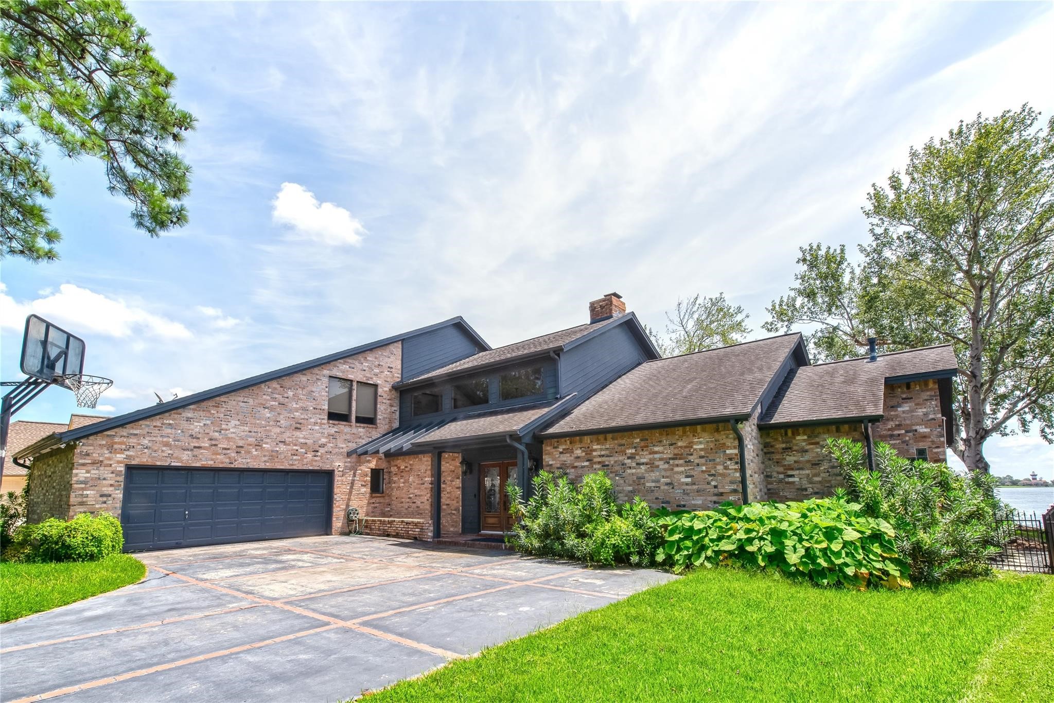 12098 Sagittarius East Willis, TX 77318 - Photo 3 of 37 a view of a house with a garden and pathway