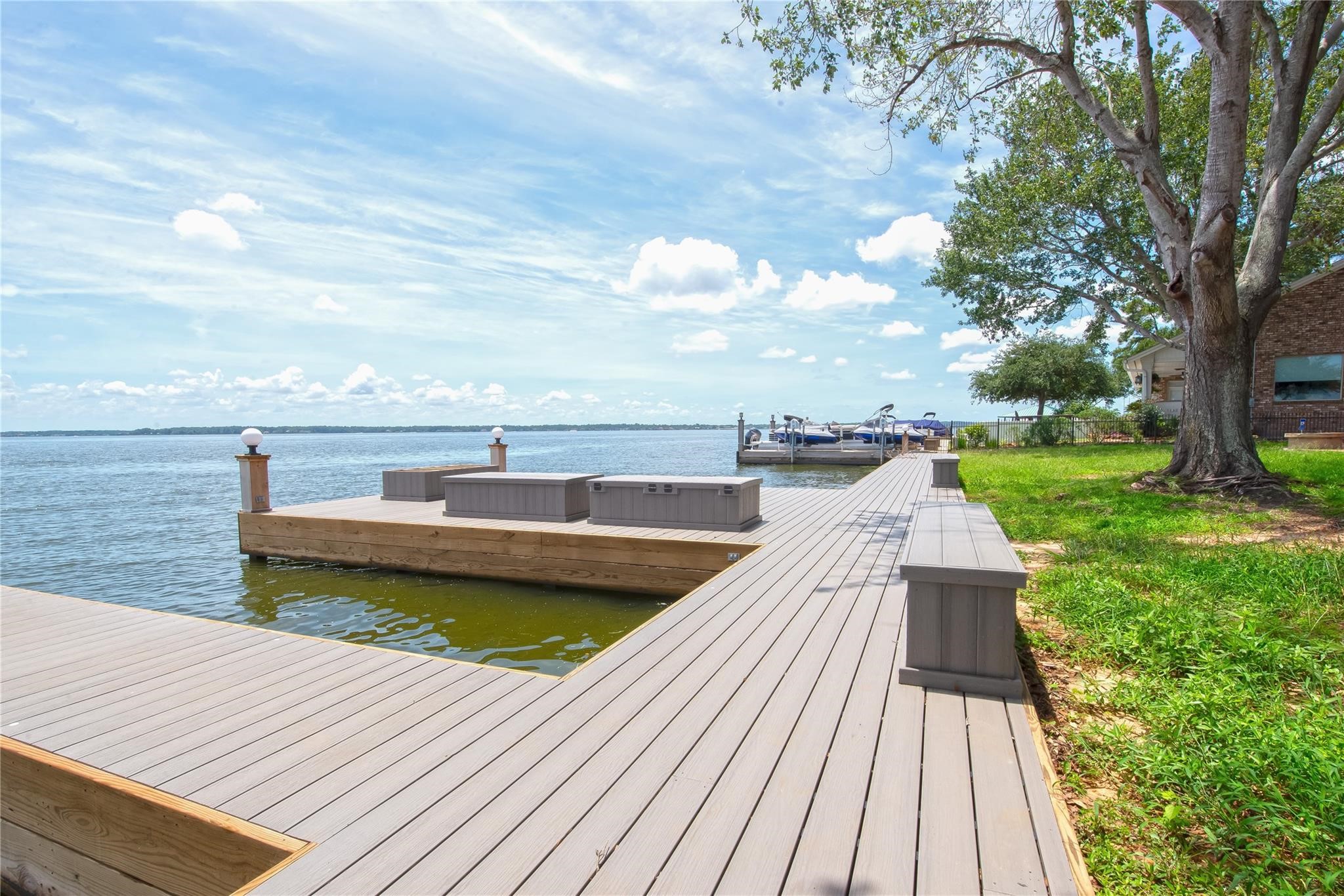 12098 Sagittarius East Willis, TX 77318 - Photo 33 of 37 a view of a terrace with wooden floor and lake view