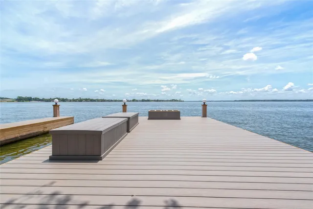 a view of a terrace with wooden floor and ocean view