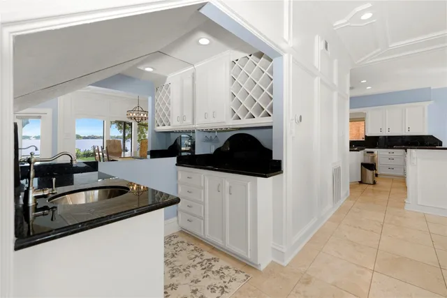 a kitchen with stainless steel appliances kitchen island granite countertop a refrigerator and a sink