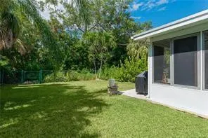 a view of a house with a yard and potted plants