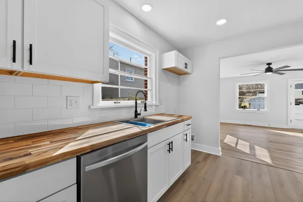 a kitchen with stainless steel appliances a stove a microwave and cabinets