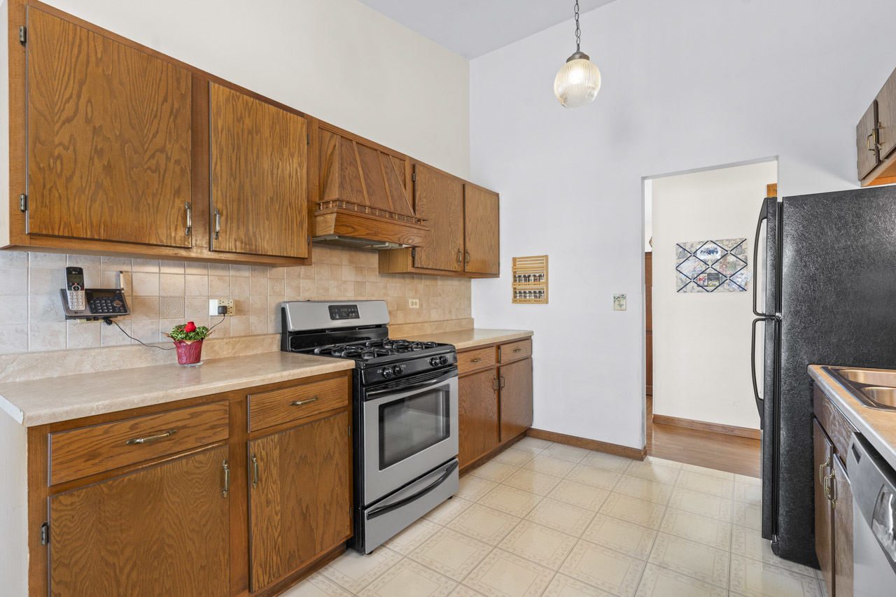 1106 Pheasant Trail Carol Stream, IL 60188 - Photo 16 of 33 a kitchen with stainless steel appliances granite countertop a stove a refrigerator and a sink