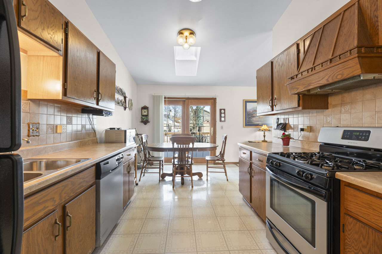 1106 Pheasant Trail Carol Stream, IL 60188 - Photo 17 of 33 a kitchen with stainless steel appliances granite countertop a stove a sink and a microwave