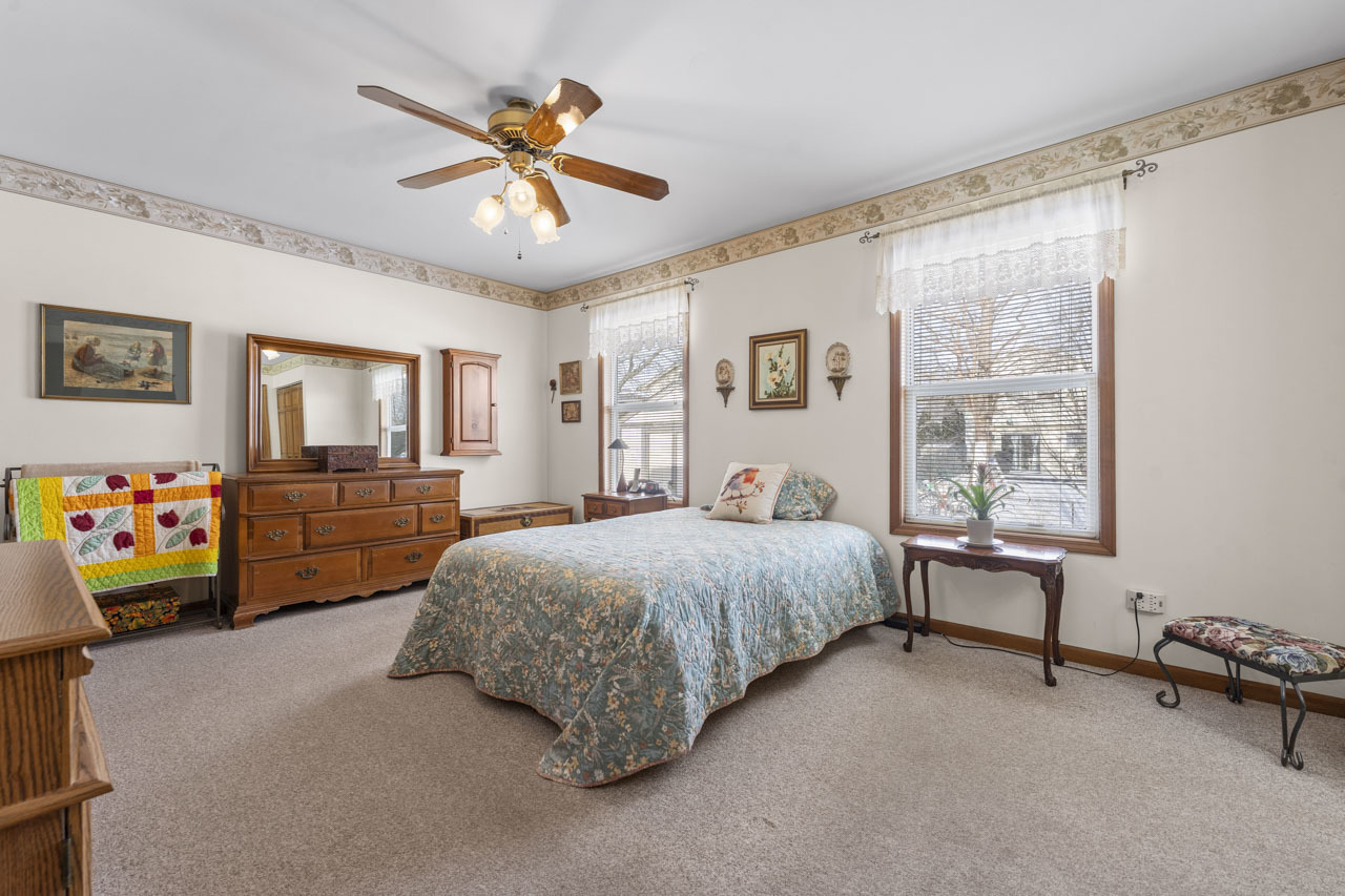 1106 Pheasant Trail Carol Stream, IL 60188 - Photo 18 of 33 a bedroom with a bed and a chandelier