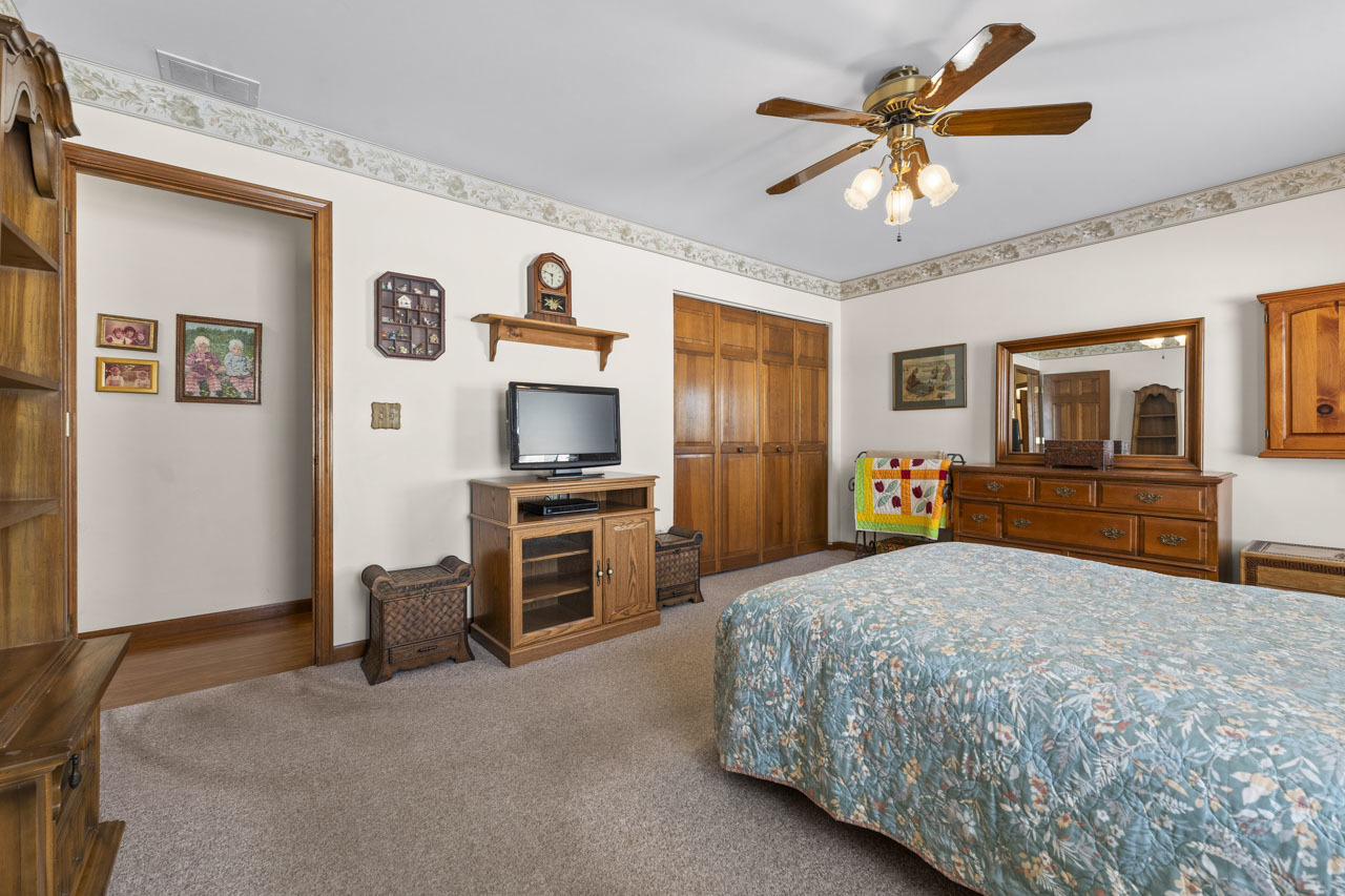 1106 Pheasant Trail Carol Stream, IL 60188 - Photo 19 of 33 a bedroom with a bed and a flat screen tv