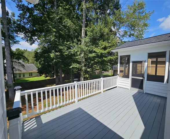 a view of a dining room with furniture kitchen and chandelier