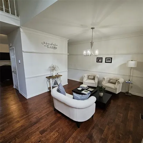 a living room with furniture and floor to ceiling windows