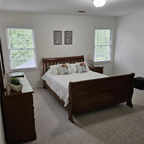 a kitchen with stainless steel appliances granite countertop a sink a stove a refrigerator a center island with wooden floor and cabinets