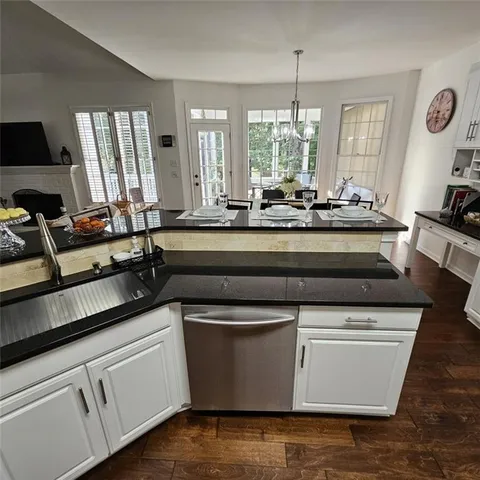 a sign of golf club on a stone wall