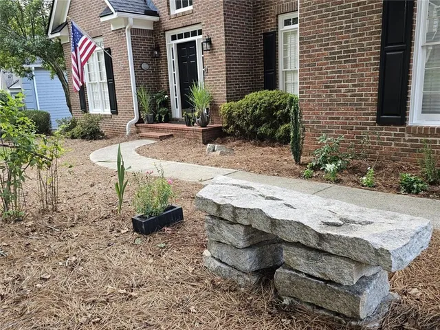 a kitchen with granite countertop a stove top oven a sink a counter space and cabinets