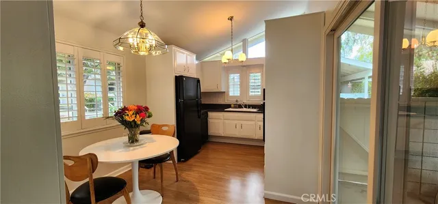 a dining room with furniture a chandelier and window