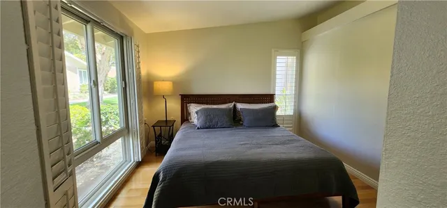 a bed sitting in a bedroom next to a window