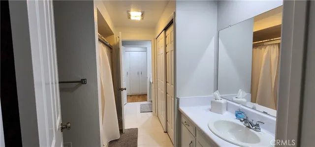 a bathroom with a double vanity sink mirror and shower