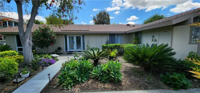 a view of a house with plants