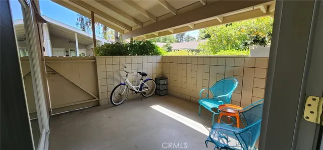 a view of a chairs and table in the back yard of the house
