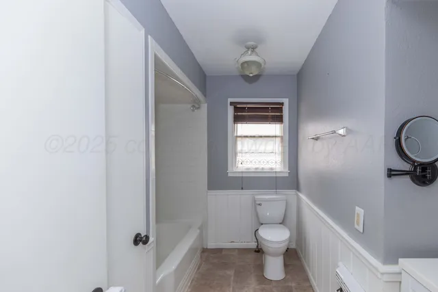 a bathroom with a toilet a sink and bathtub