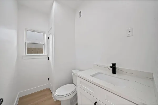 a bathroom with a sink a toilet and a mirror