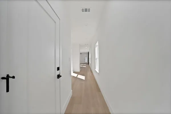 a view of a hallway with a white walls