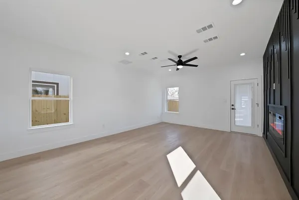 wooden floor in an empty room with a window