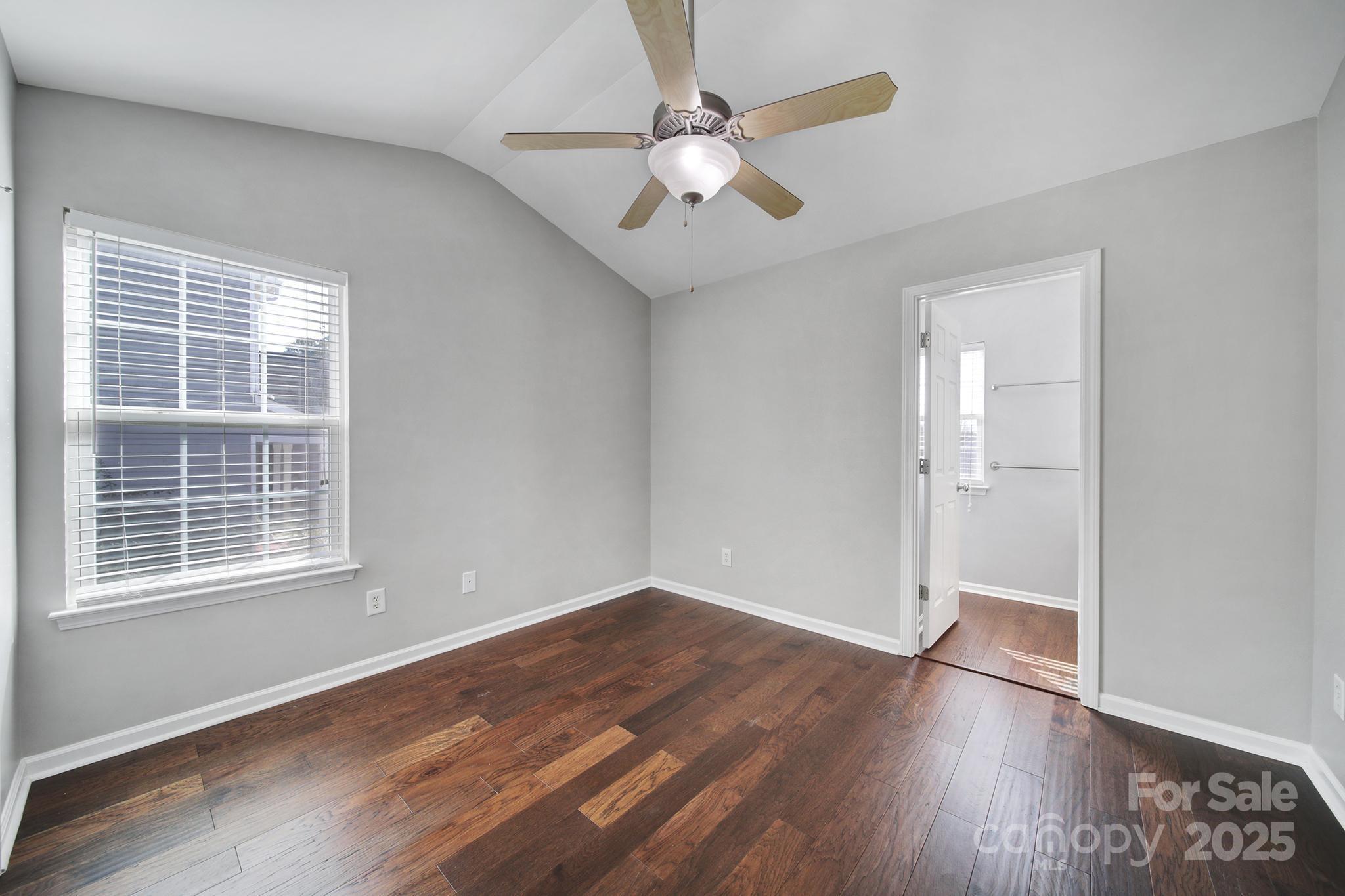 2001 Roscommon Drive Clover, SC 29710 - Photo 20 of 37 an empty room with wooden floor chandelier fan and windows