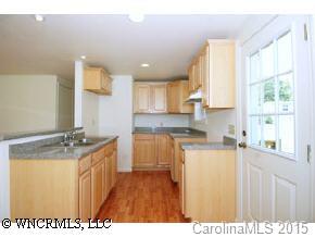 4438 Old River Road Waynesville, NC 28786 - Photo 3 of 8 a kitchen with a sink stove and cabinets