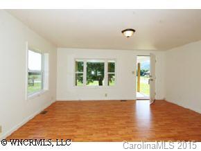 4438 Old River Road Waynesville, NC 28786 - Photo 6 of 8 a view of an empty room with wooden floor and a window