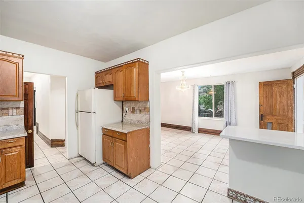 a kitchen with stainless steel appliances a refrigerator and a stove top oven
