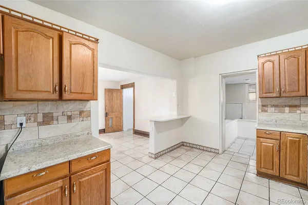 a kitchen with a sink cabinets and window