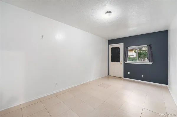 an empty room with windows and closet