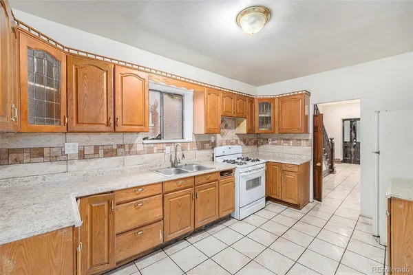 a kitchen with a sink stove and cabinets